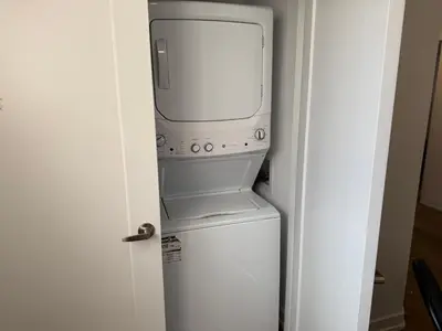 a microwave oven sitting on top of a refrigerator at Bright Escape Falls Retreat in Niagara Falls
