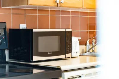a microwave sitting on top of a kitchen counter at Chic Fort York Studio Cozy Retreat in Downtown TO in Toronto