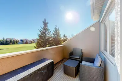 a balcony with a bench and a chair and a window at Wintergreen 222 in Blue Mountains