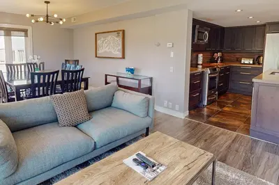 a living room and kitchen with a couch and a table at Sierra Lane 218 in Blue Mountains