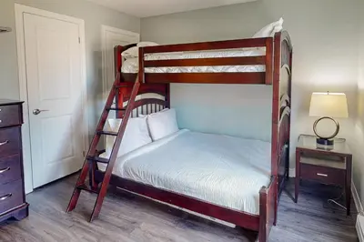 a bedroom with two bunk beds and a lamp at Sierra Lane 218 in Blue Mountains