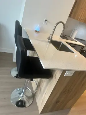 an office with a desk with a chair and a sink at Luxury Condo with Hottub, outdoor firepit & Bowlin in Kitchener