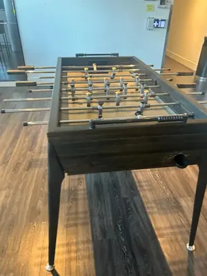 a large wooden billiard table with at Luxury Condo with Hottub, outdoor firepit & Bowlin in Kitchener