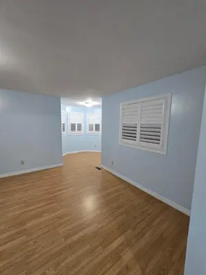 an empty living room with a hard wood floor at Peaceful Country Home on 25 Acres of Wooded Land in Alliston