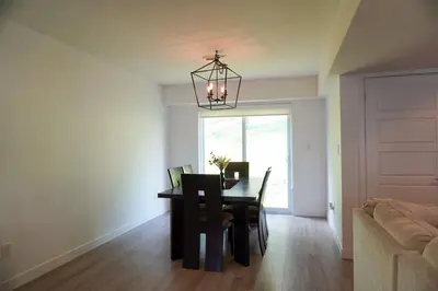 a dining room with a table with chairs and a chandelier at Entire 3 bedroom townhouse in Cambridge