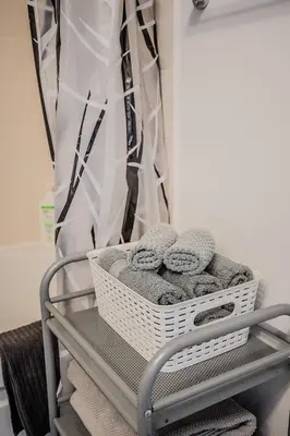 a basket of towels on a shelf in a bathroom at High Floor 1 Bedroom Condo City View Downtown Toronto in Toronto