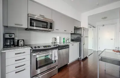 a kitchen with stainless steel appliances and a microwave at High Floor 1 Bedroom Condo City View Downtown Toronto in Toronto