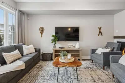 a living room with a couch and a table at Family Townhome in Historic Snowbridge in Blue Mountains