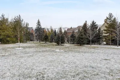 a field with trees and houses in the background at Family Townhome in Historic Snowbridge in Blue Mountains