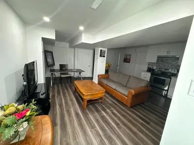 a living room with a couch and a table at Basement Suite 2 bedroom s in Oshawa