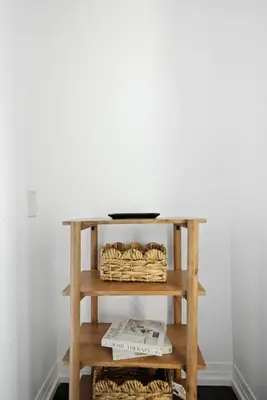 a shelf with a table with baskets on it at Chic DT TO Studio Getaway Perfect for Couples in Toronto