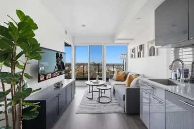 a kitchen and living room with a couch and a table at Bright 2BR Downtown Toronto Condo in Toronto