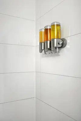 two jars on a wall in a white bathroom at Luxe Downtown Studio Near Eaton Centre & Transit in Toronto