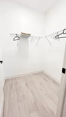 a room with white walls and a wooden floor at Yonge Finch Subway Modern Suite with En Suite Bathroom in Toronto