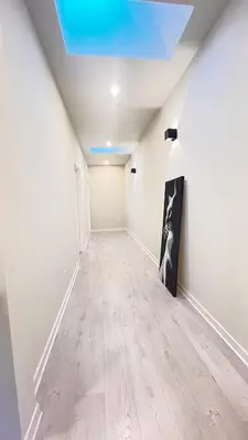 an empty hallway with white walls and a blue ceiling at Yonge Finch Subway Modern Suite with En Suite Bathroom in Toronto
