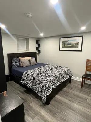a bedroom with a large bed in a room at Basement in Brampton