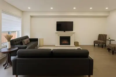a living room with a couch and a fireplace at Lux 3 Bedroom Home near Public Transit in Brampton