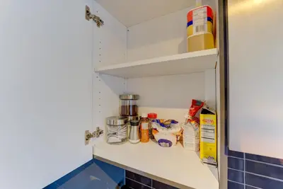 a kitchen shelf with food items on it at Downtown Luxury Unit in Toronto