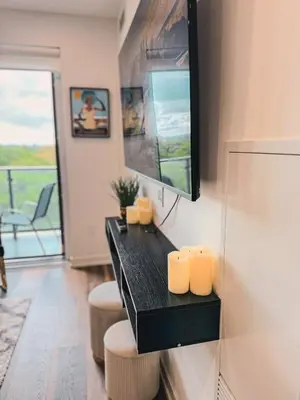 a room with a black table with three candles at LuxCondo in the Downtown Kitchener Uptown Waterloo in Kitchener
