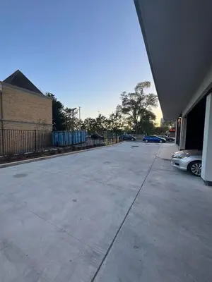 an empty parking lot with cars parked next to a building at New Condo With Large Balcony - The Queensway Retreat in Toronto