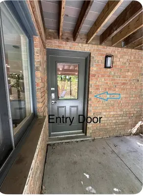 an entry door to a brick building with a sidewalk at Luxurious Pvt room & Pvt heated floor bathroom near Airport in Kitchener