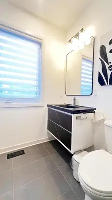a bathroom with a sink and a toilet and a mirror at Modern Room with En Suite Bath Yonge Finch Sub in Toronto