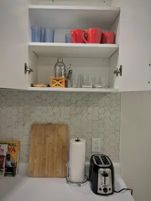 a kitchen counter with a toaster and a cutting board at Your cozy Caribbean-inspired stay just 1 hour north of Toronto in Alliston