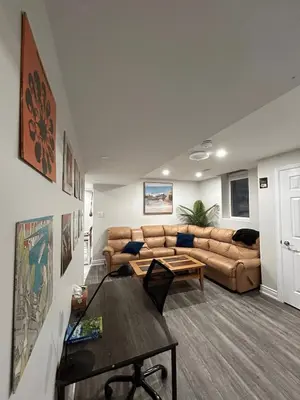 a living room with a couch and a table at Your cozy Caribbean-inspired stay just 1 hour north of Toronto in Alliston