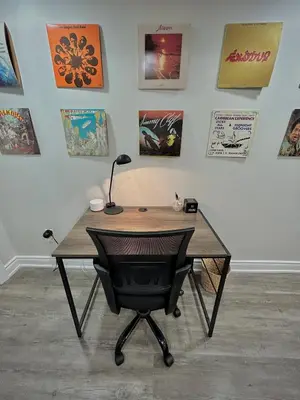 a desk with a lamp and a chair in front of a wall at Your cozy Caribbean-inspired stay just 1 hour north of Toronto in Alliston