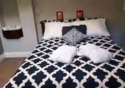 a bedroom with a black and white bed with two pillows at Cozy Suite in Milton ON Keyless Entry No Pets in Milton