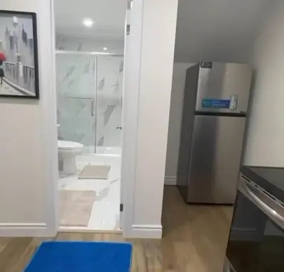 a bathroom with a shower and a refrigerator at 2 Bedroom private Basement apartment in Markham