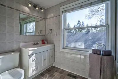 a bathroom with a sink toilet and a window at Riesling Room Old Town in Niagara on the Lake