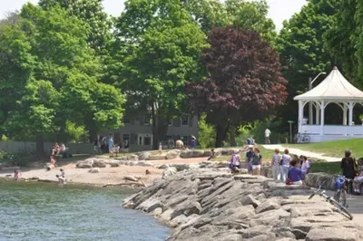 a group of people standing on a rock near the water at Riesling Room Old Town in Niagara on the Lake