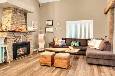a living room with a couch and a fireplace at Family friendly Getaway Steps to the beach in Fort Erie