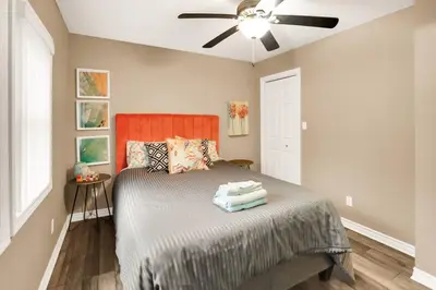 a bedroom with a bed with a ceiling fan at Family friendly Getaway Steps to the beach in Fort Erie