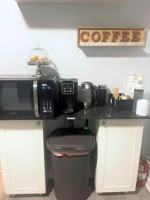 a kitchen with a counter with a microwave and a trash can at Cozy Private Room Near Downtown Toronto in Toronto