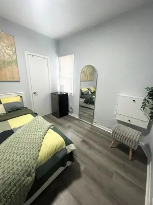 a bedroom with a bed and a dresser and a mirror at Cozy Private Room Near Downtown Toronto in Toronto