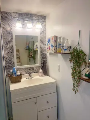 a bathroom with a sink and a mirror at Modern & Cozy Basement Suite Lower Unit - 3 rooms -1 King bed - 2 Car Parking in Pickering