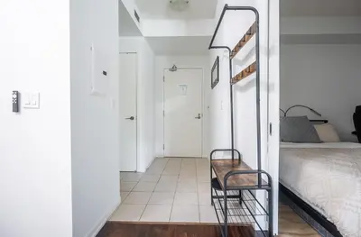 a room with a bed and a chair in it at 1 Bedroom plus Den Condo Garden View Fort York Downtown Toronto in Toronto