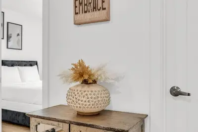 a vase sitting on a table in a bedroom at 5 Mins to the Falls Brand New Home in Niagara Falls