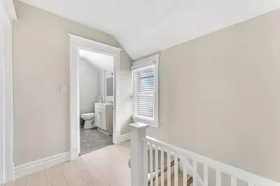 a white room with a staircase and a bathroom at Pristine Home 5 min walk to Clifton Hill in Niagara Falls