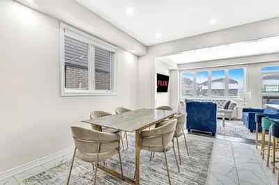 a dining room with a table and chairs at Designer Home in Niagara Falls in Thorold