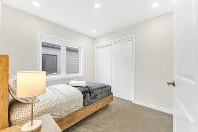 a bedroom with a bed and a window at Designer Home in Niagara Falls in Thorold