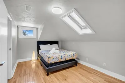 a bedroom with a bed and a skylight at War of 1812 Battlefield Home by Falls in Niagara Falls