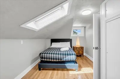 a bedroom with a bed and a skylight at War of 1812 Battlefield Home by Falls in Niagara Falls