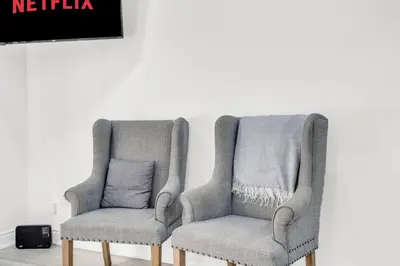 two chairs sitting next to each other in a room at Spacious 6BR Getaway Sleeps 16 Yard and Parking in Brampton