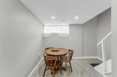 a dining room with a table and chairs at Spacious 6BR Getaway Sleeps 16 Yard and Parking in Brampton