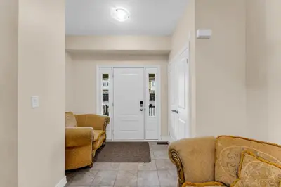 a living room with two couches and two chairs at Bright and Stylish Family Home Near Niagara Falls in Thorold