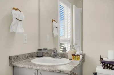 a bathroom with a sink and a mirror at Stylish Niagara Falls Getaway with Rooftop City Views in Niagara Falls