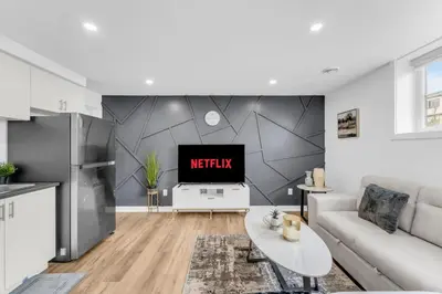 a living room with a tv on a wall at New 2BD Townhouse Mins from Niagara Falls in Niagara Falls